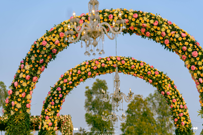 Rich cascade of orchids hanging over table charger plates